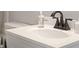 Close-up of the bathroom sink featuring modern bronze-toned fixtures, and a white countertop at 921 S State Ave, Indianapolis, IN 46203