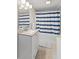 Well-lit bathroom with granite vanity, bathtub with curtain, and neutral decor at 923 S State Ave, Indianapolis, IN 46203