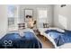 Stylishly decorated bedroom features two twin beds with soft carpet and lots of natural light at 923 S State Ave, Indianapolis, IN 46203