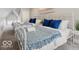 Charming bedroom featuring two beds, blue accents, and cozy decor in a well-lit space at 923 S State Ave, Indianapolis, IN 46203