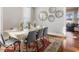 Comfortable dining area features seating for six, stylish decor, and hardwood floors, creating a warm and inviting space at 923 S State Ave, Indianapolis, IN 46203