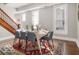 Bright dining room showcases hardwood floors, windows with blinds, and a table set for six under modern lighting at 923 S State Ave, Indianapolis, IN 46203