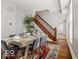 Bright dining room features hardwood floors, wooden staircase, and an elegant table setting for a welcoming atmosphere at 923 S State Ave, Indianapolis, IN 46203