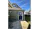 Exterior featuring the side of a home with green siding and a dark blue door at 923 S State Ave, Indianapolis, IN 46203
