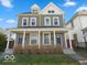 Charming two-story home featuring a covered front porch, well-maintained lawn, and classic architectural details at 923 S State Ave, Indianapolis, IN 46203
