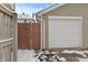 A white garage door and wooden fence are visible, suggesting privacy and functionality at 923 S State Ave, Indianapolis, IN 46203