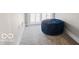 Hallway with a plush blue ottoman, carpet, and neutral color scheme at 923 S State Ave, Indianapolis, IN 46203