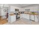 Bright kitchen featuring white cabinets, stainless steel appliances, and wood countertops, seamlessly connected to adjacent living space at 923 S State Ave, Indianapolis, IN 46203