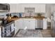 Modern kitchen boasts white cabinets, stainless steel appliances, wood countertops, and a stylish backsplash for cooking at 923 S State Ave, Indianapolis, IN 46203