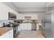 Well-lit kitchen with white cabinets, stainless steel appliances, and wood countertops offers a modern and functional cooking space at 923 S State Ave, Indianapolis, IN 46203