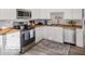 Modern kitchen boasts white cabinets, stainless steel appliances, and wood countertops, creating a clean and stylish cooking space at 923 S State Ave, Indianapolis, IN 46203