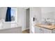 Bright laundry area features a modern sink and adjacent washer and dryer hookups at 923 S State Ave, Indianapolis, IN 46203