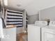 Functional laundry room with modern washer and dryer, plus adjacent bathroom area at 923 S State Ave, Indianapolis, IN 46203