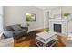 Comfortable living room featuring stylish seating, hardwood floors, and a cozy fireplace at 923 S State Ave, Indianapolis, IN 46203