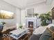 Cozy living room with a decorative fireplace, hardwood floors, and comfortable seating at 923 S State Ave, Indianapolis, IN 46203