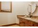Powder room features a granite countertop vanity, round mirror and soft natural light with a wood trimmed window at 9387 Sullivan Pl, Zionsville, IN 46077