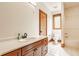 Well-lit bathroom featuring a single sink vanity with wood cabinets and white countertop at 9387 Sullivan Pl, Zionsville, IN 46077