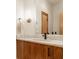 Modern bathroom vanity with marble countertop, wood cabinet and matte black faucet at 9387 Sullivan Pl, Zionsville, IN 46077
