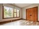Bedroom with a large window showcasing wooded views, light gray walls and hardwood floors at 9387 Sullivan Pl, Zionsville, IN 46077