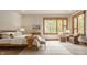 Well-lit bedroom with large windows, wood trim and light wood flooring at 9387 Sullivan Pl, Zionsville, IN 46077