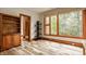 Bright bedroom featuring hardwood floors, a large window with natural light, and wooden trim at 9387 Sullivan Pl, Zionsville, IN 46077