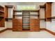 Walk-in closet features custom built-in shelving, drawers, and hanging rods for optimal organization and storage solutions at 9387 Sullivan Pl, Zionsville, IN 46077