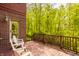 An outdoor deck with chairs, overlooking a scenic wooded area, ideal for relaxation and privacy at 9387 Sullivan Pl, Zionsville, IN 46077