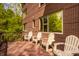 A relaxing outdoor deck area with four chairs, perfect for enjoying the surrounding nature at 9387 Sullivan Pl, Zionsville, IN 46077