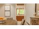 Dining room showing view into kitchen with wood cabinets and bright window at 9387 Sullivan Pl, Zionsville, IN 46077