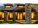 Warm and inviting entrance with brick and stone exterior and natural wood accents at 9387 Sullivan Pl, Zionsville, IN 46077