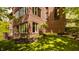 Exterior view of a brick home with multiple windows, green grass, and a lush yard at 9387 Sullivan Pl, Zionsville, IN 46077