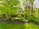 Exterior shot highlighting the home's architecture surrounded by mature trees at 9387 Sullivan Pl, Zionsville, IN 46077