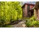 Exterior of home featuring brick accents, large windows, and a stone pathway through a lush landscape at 9387 Sullivan Pl, Zionsville, IN 46077