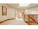 Hallway with wood trim, neutral walls, carpet and a skylight for an abundance of natural light at 9387 Sullivan Pl, Zionsville, IN 46077