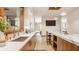Bright kitchen with wooden cabinets, stone countertops, stainless appliances, and a large window view at 9387 Sullivan Pl, Zionsville, IN 46077