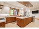 Modern kitchen with wood cabinets, stainless steel appliances, kitchen island, and ample lighting at 9387 Sullivan Pl, Zionsville, IN 46077