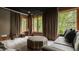 Cozy living room features dark gray walls, large windows, and a gray sofa at 9387 Sullivan Pl, Zionsville, IN 46077