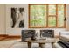 Sunlit living room showcases stylish chairs and beautiful outdoor views at 9387 Sullivan Pl, Zionsville, IN 46077