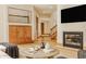 Stylish living room features a fireplace, custom cabinetry, and staircase access at 9387 Sullivan Pl, Zionsville, IN 46077