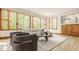 Bright living room with large windows, hardwood floors, modern sofa, area rug and unique furniture at 9387 Sullivan Pl, Zionsville, IN 46077
