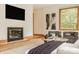 Modern living area with sleek fireplace, warm wood trim, and comfortable seating at 9387 Sullivan Pl, Zionsville, IN 46077