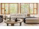 Living room features hardwood floors, many large windows with an oversized sofa, and modern furniture at 9387 Sullivan Pl, Zionsville, IN 46077
