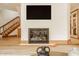 Close-up on modern fireplace and natural wood trim in a bright living space at 9387 Sullivan Pl, Zionsville, IN 46077