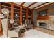 Warm and inviting living room with custom wood built-ins and stone fireplace at 9387 Sullivan Pl, Zionsville, IN 46077