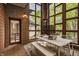 Cozy patio featuring brick walls, a white dining set, and natural light from large windows at 9387 Sullivan Pl, Zionsville, IN 46077