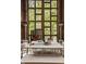 Inviting patio with brick walls and large windows, furnished with a white table and chairs at 9387 Sullivan Pl, Zionsville, IN 46077