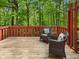 Inviting wooden deck with comfortable wicker chairs offers a serene outdoor living space surrounded by lush greenery at 9493 Timber View Dr, Indianapolis, IN 46250