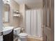 Bathroom with brown vanity, mirror, and white shower curtain at 9493 Timber View Dr, Indianapolis, IN 46250