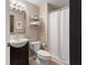 Bathroom with brown vanity, mirror, and white shower curtain at 9493 Timber View Dr, Indianapolis, IN 46250