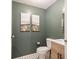 Stylish powder room with modern fixtures, wood vanity, gold accents and decorative artwork at 9493 Timber View Dr, Indianapolis, IN 46250